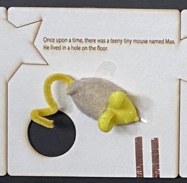 Image of 3D printed mouse and book page with mouse hole cut out.