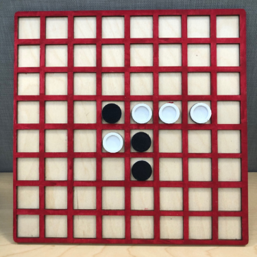 Tactile gameboard for Othello showing red grid on light background and black and white playing pieces.