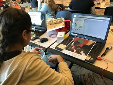 Girl working on scratch program at computer