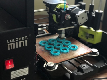 3D printer printing textured playing pieces