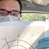 Neal Mckenzie wearing a mask and displaying braille math diagrams.