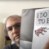 Max Bogue holding 3D pen enhanced pages of elephant and piggy picture book