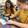 Two students working with 3D printing pens