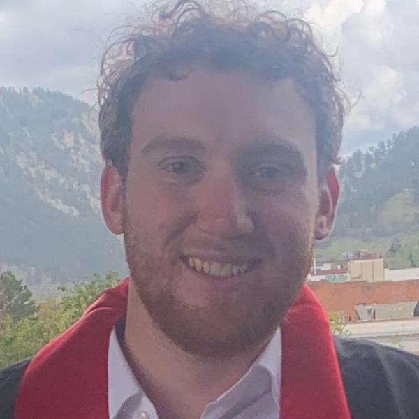 Man smiling with a red scarf