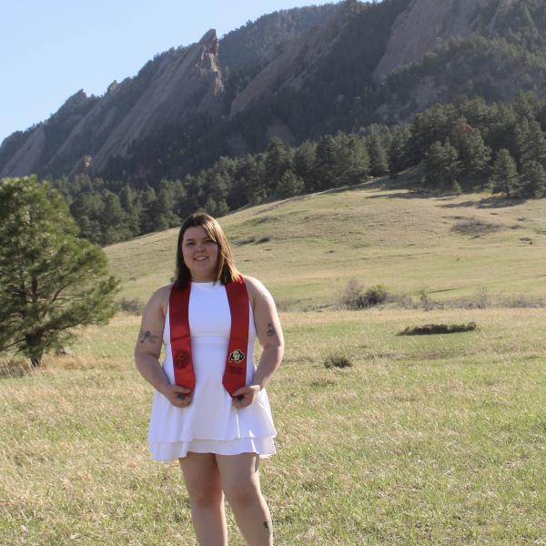 Woman in a white dress in front of mountains