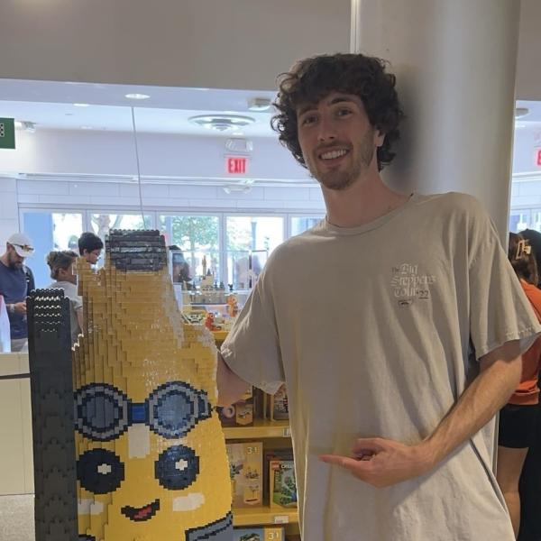 Person standing next to a blow-up banana