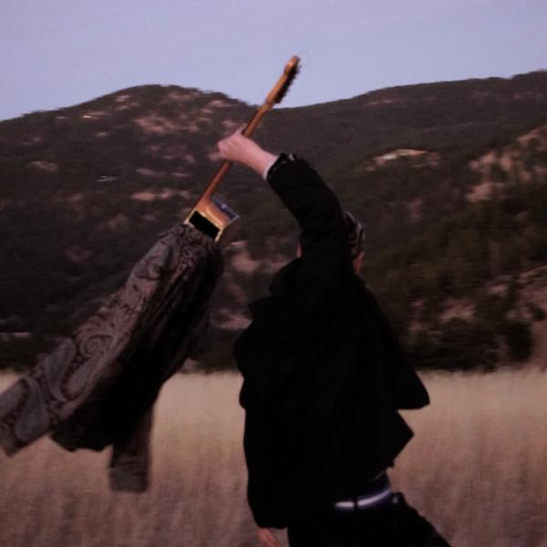 Samuel Holding a Guitar in Front of Mountains