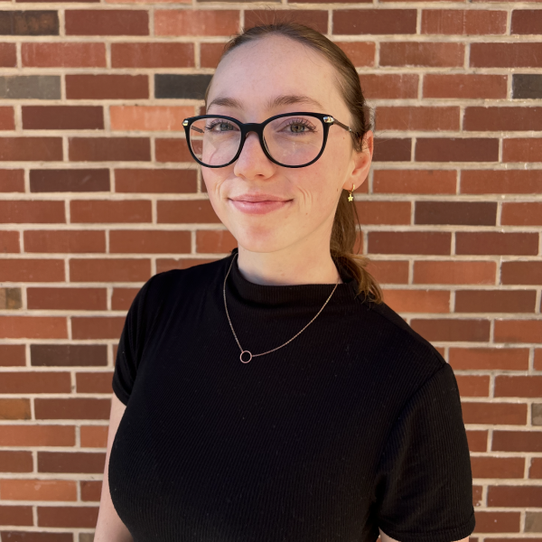 Portrait of a woman with black shirt and glasses