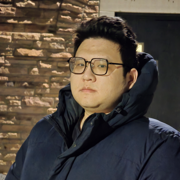Yutong Standing in Front of a Wall