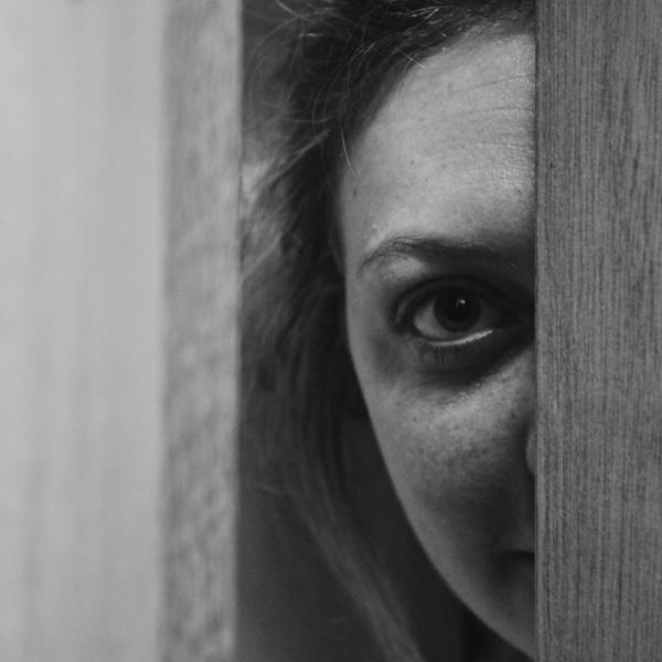 Face peeping through door gap