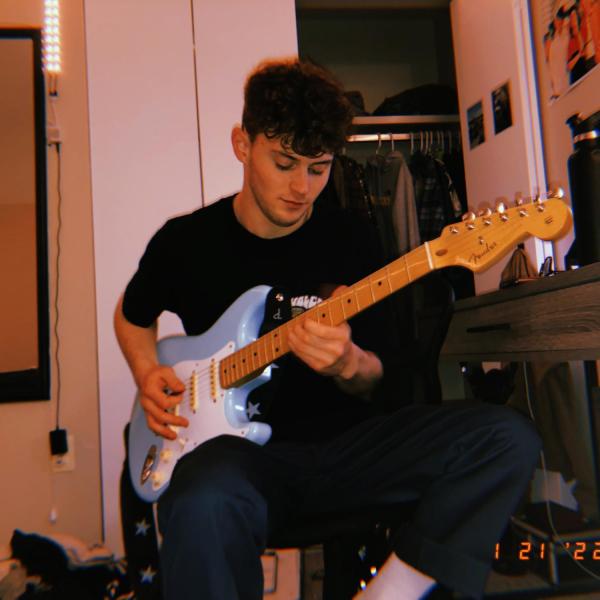 man playing an electric guitar