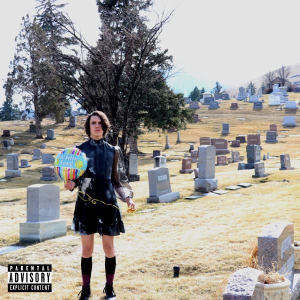 Artist in graveyard holding a balloon
