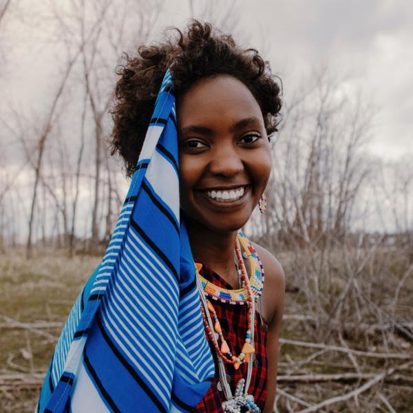 woman smiling wearing bright colored clothing