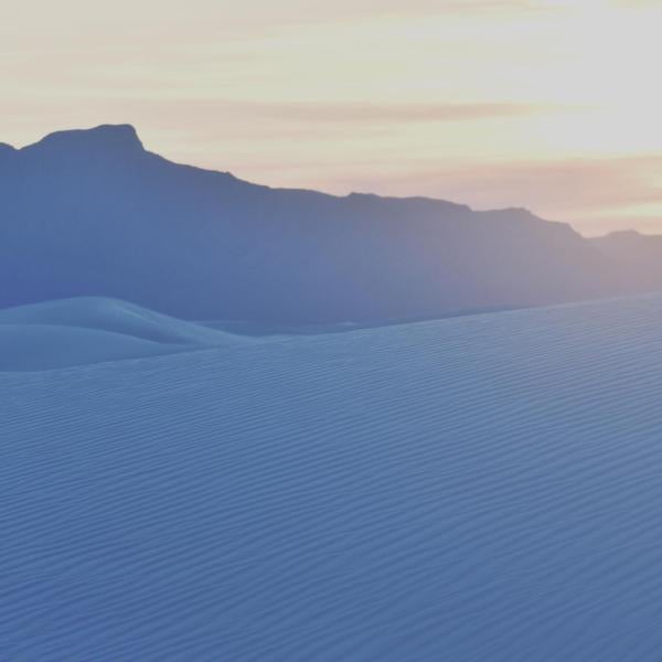 sand dunes and mountains with sunset