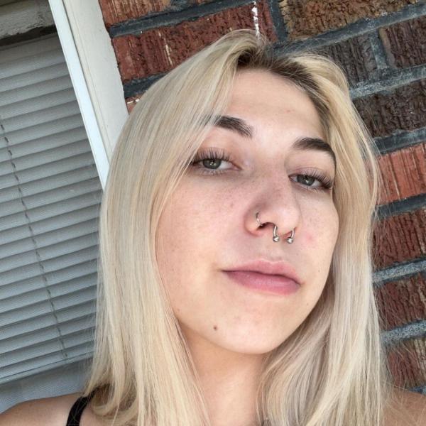 woman in front of a brick wall