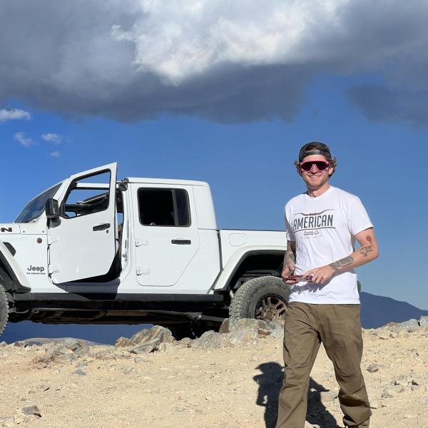 man standing in front of a car