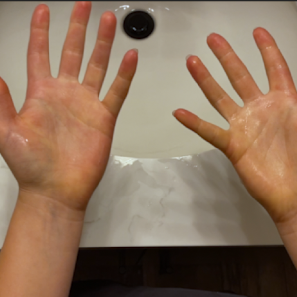 Hands over a bathroom sink
