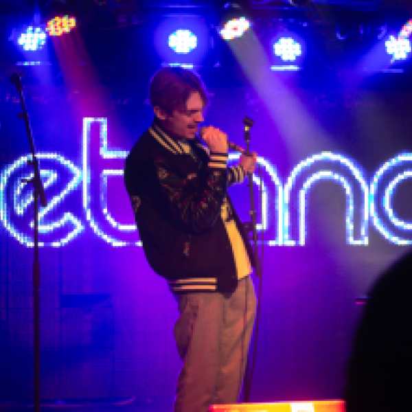 performer singing on stage