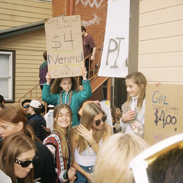 Several people outside holding signs