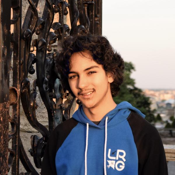man standing in front of a gate