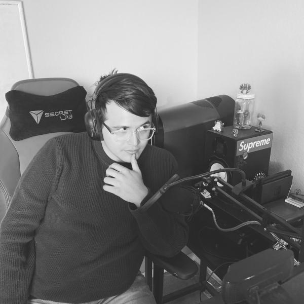 Black and white image of a person sitting and listening to music