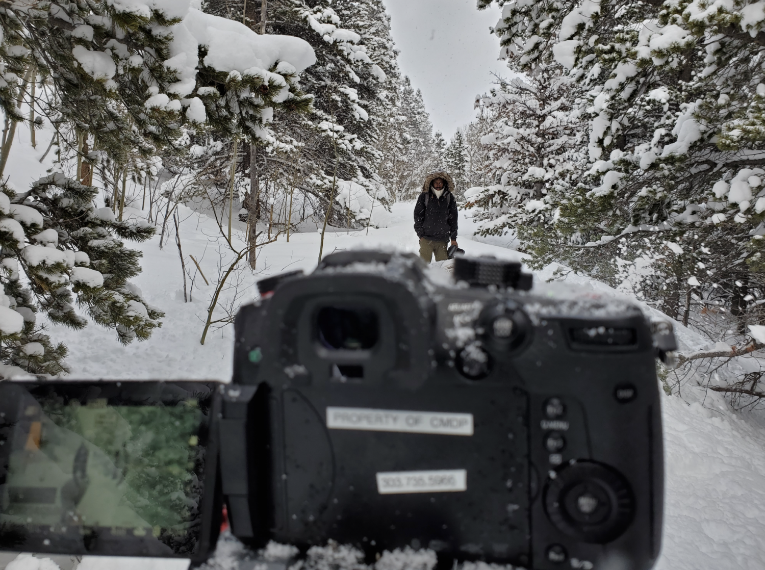 Behind the scenes camera view of actor in the snow