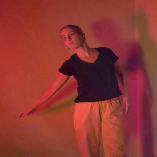 Person moving in a red-lit room