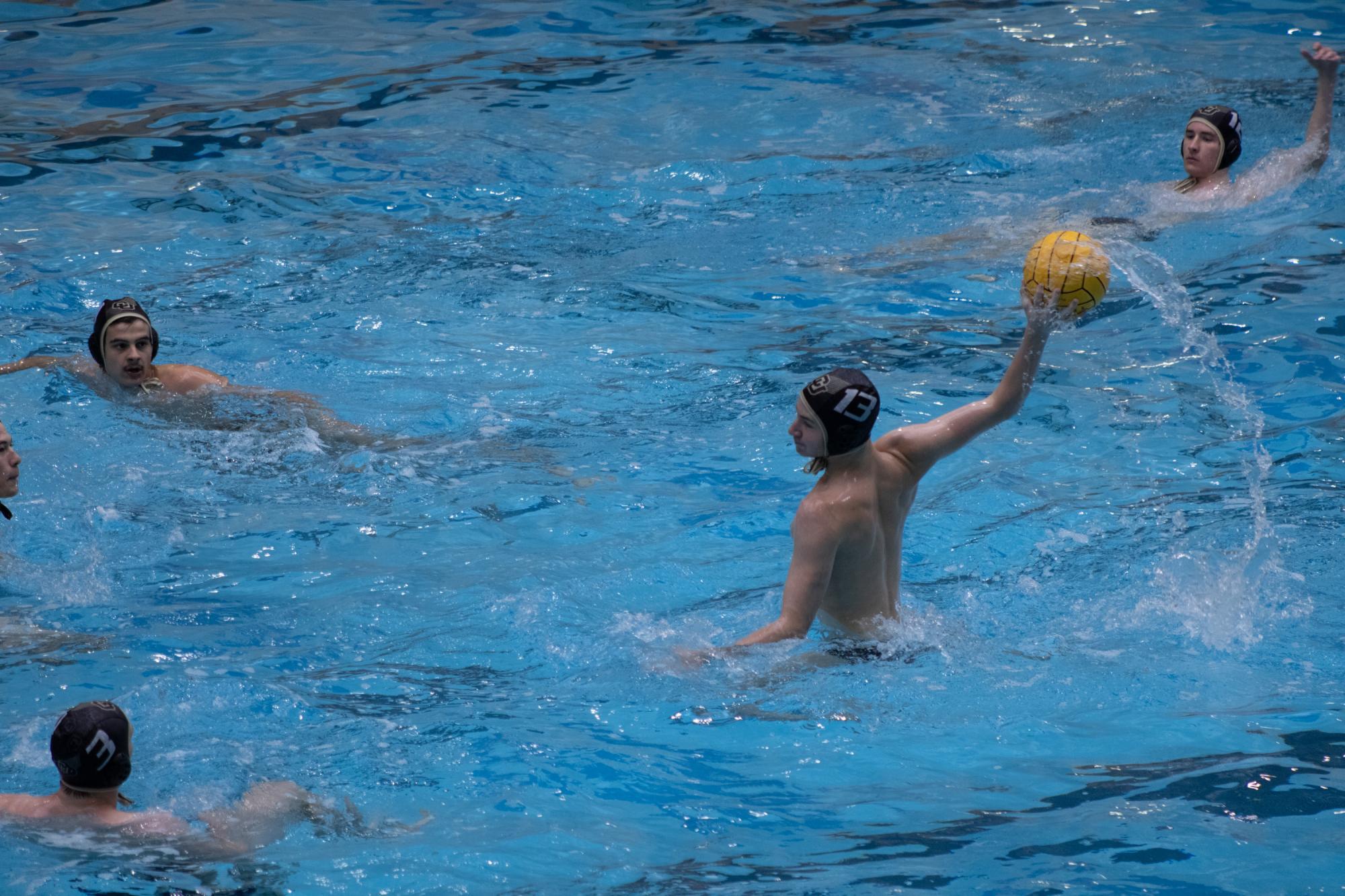 CU Men's Club Water Polo player shoots on goal during a matchup against the University of Denver at the Veterans Memorial Aquatic Center. This goal opened up the scoring for a busy evening of games. #13 would go on to pot three more goals in the match while CU would carry on to win 3 of 4 in their Saturday slate.