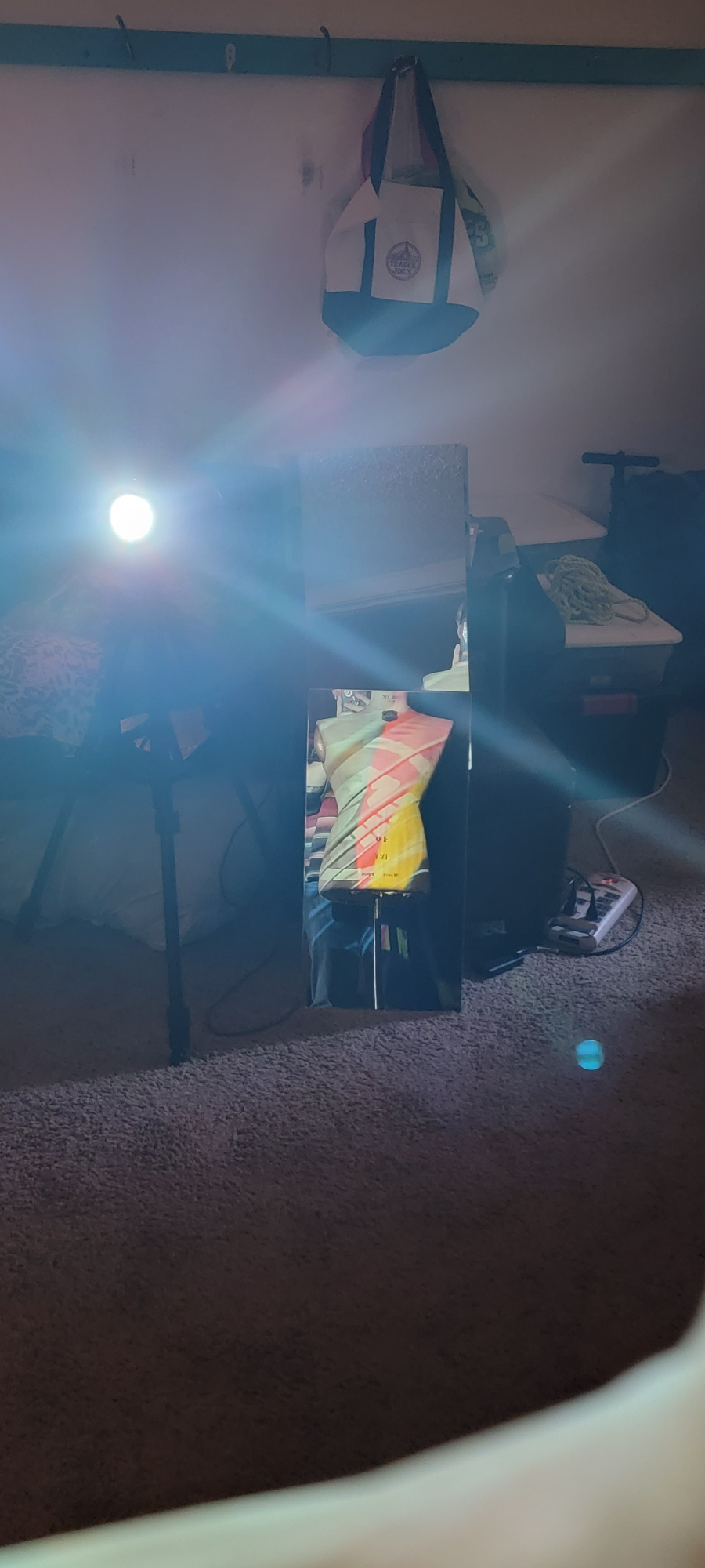 mannequin in a mirror with a projection on its body