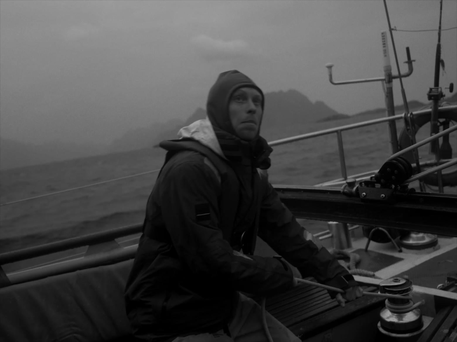 B&W sailor on boat facing the cold