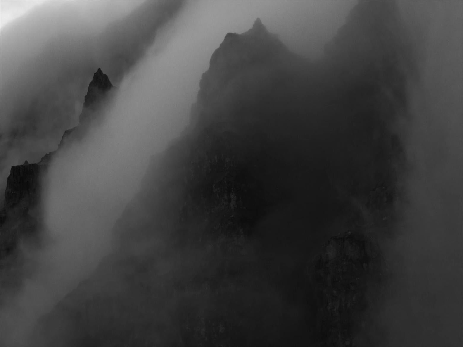 B&W rugged mountain landscape with low hanging clouds