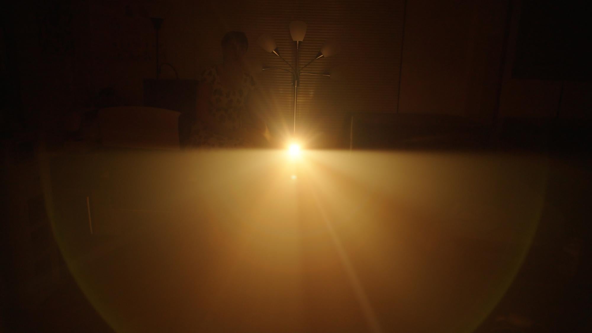 Camera looking directly into projector with a red orange haze surrounding it