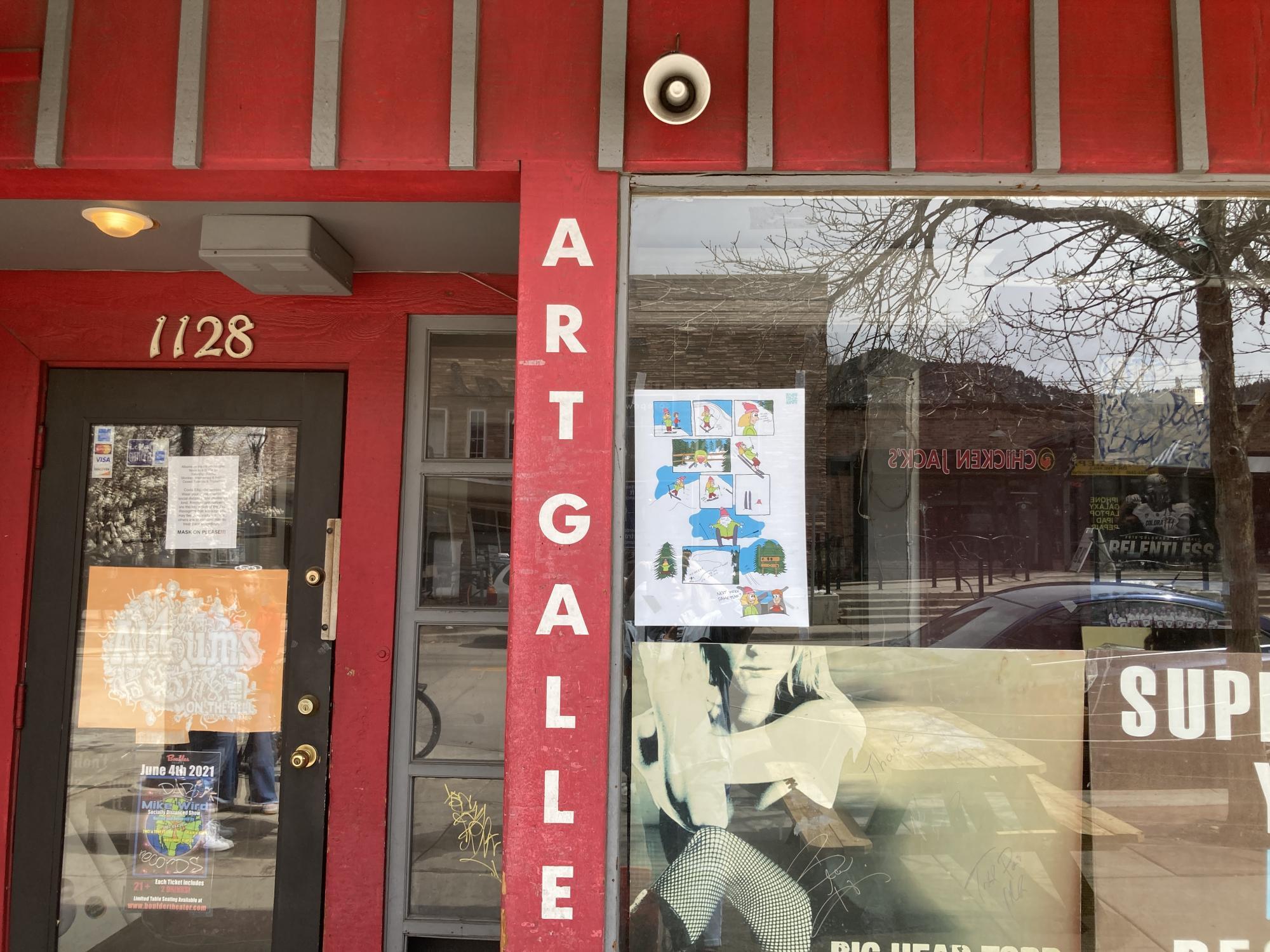 Art gallery storefront with posters on the window
