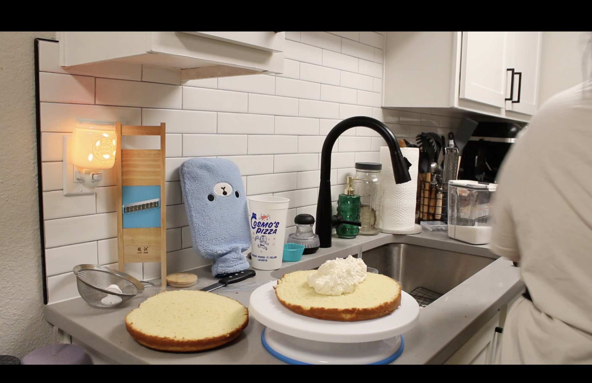 a kitchen with an open faced cake with a dollop of icing on it