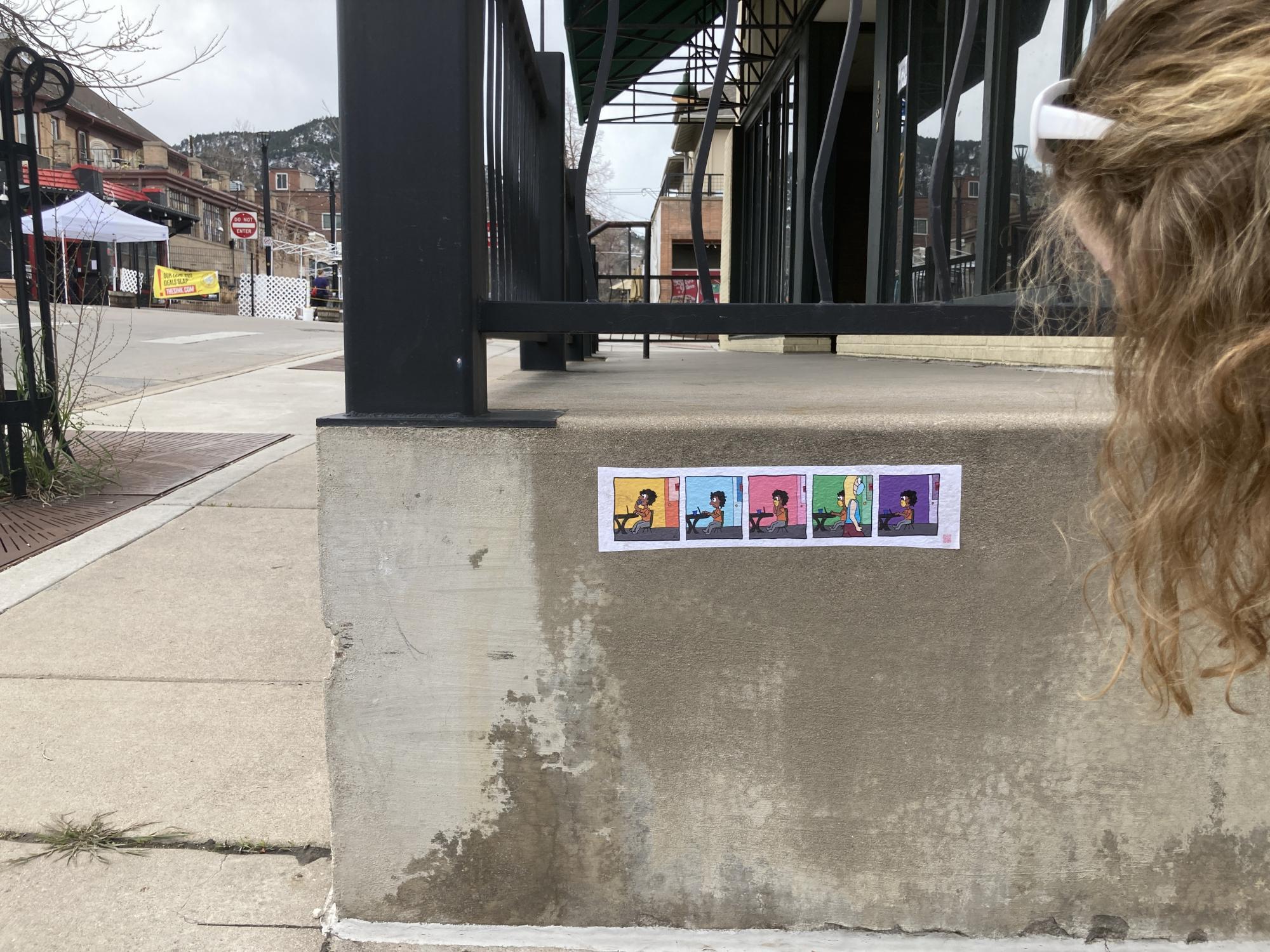 Comic strip pasted to wall outdoors on the street