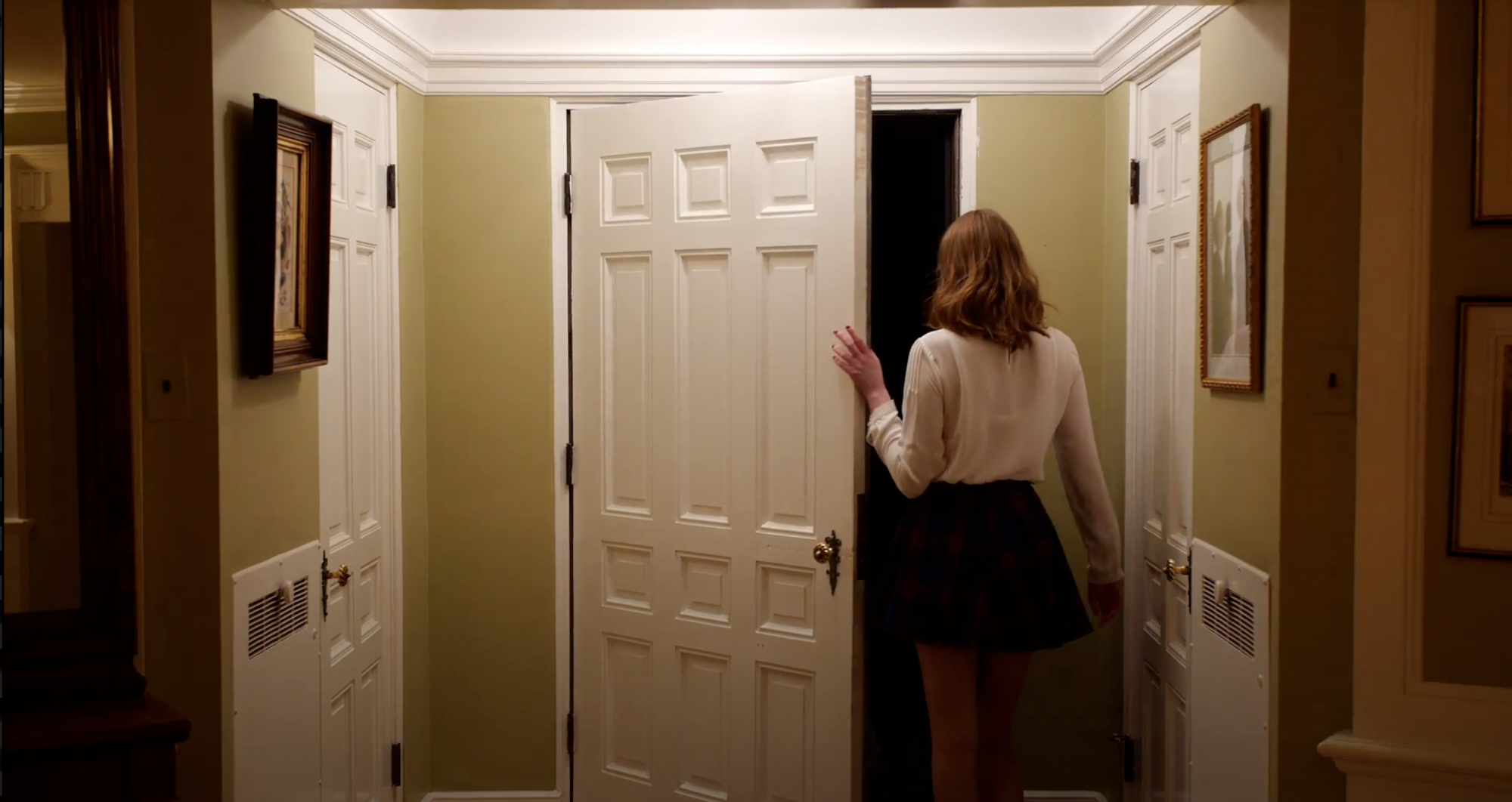 Woman inside opening the front door