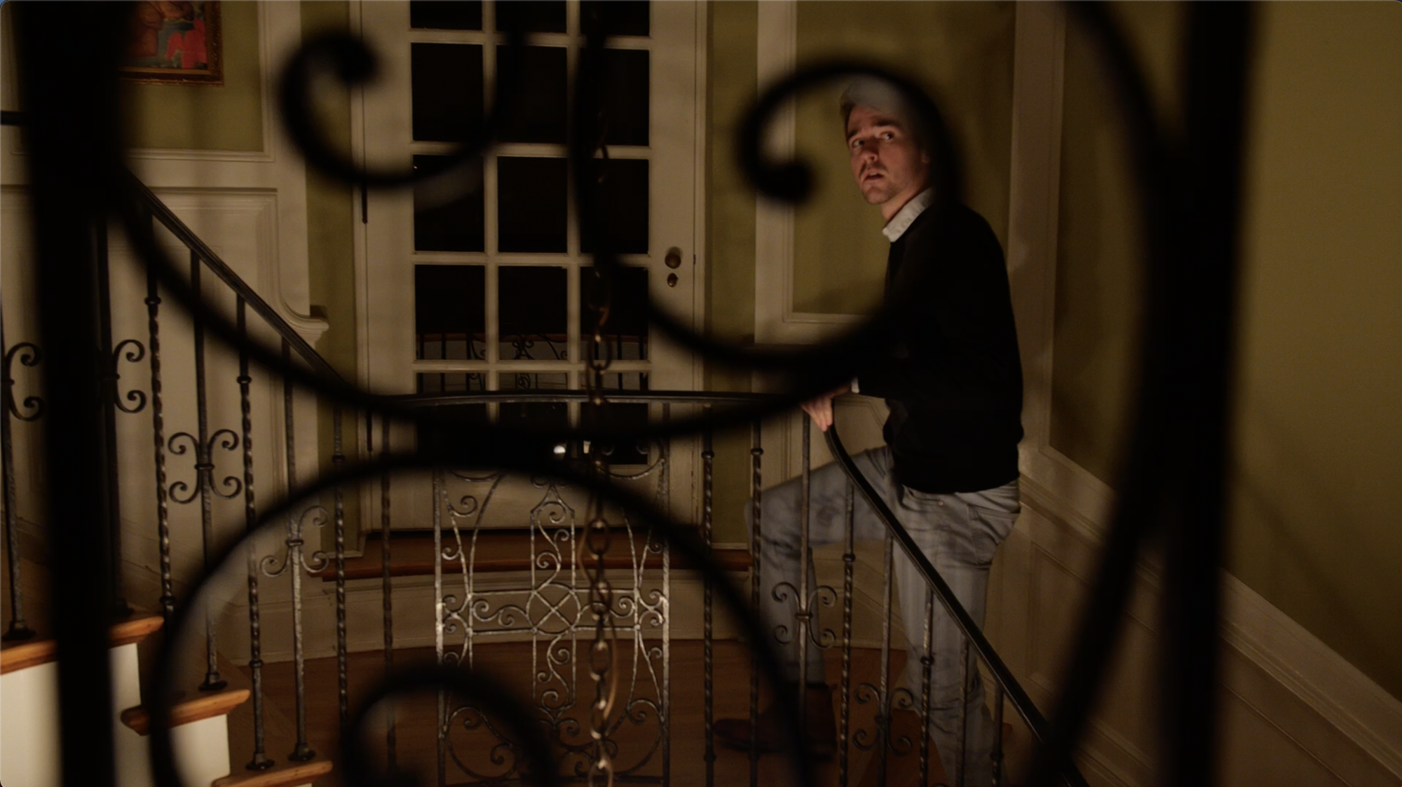 A man walking up the stairs looking scared