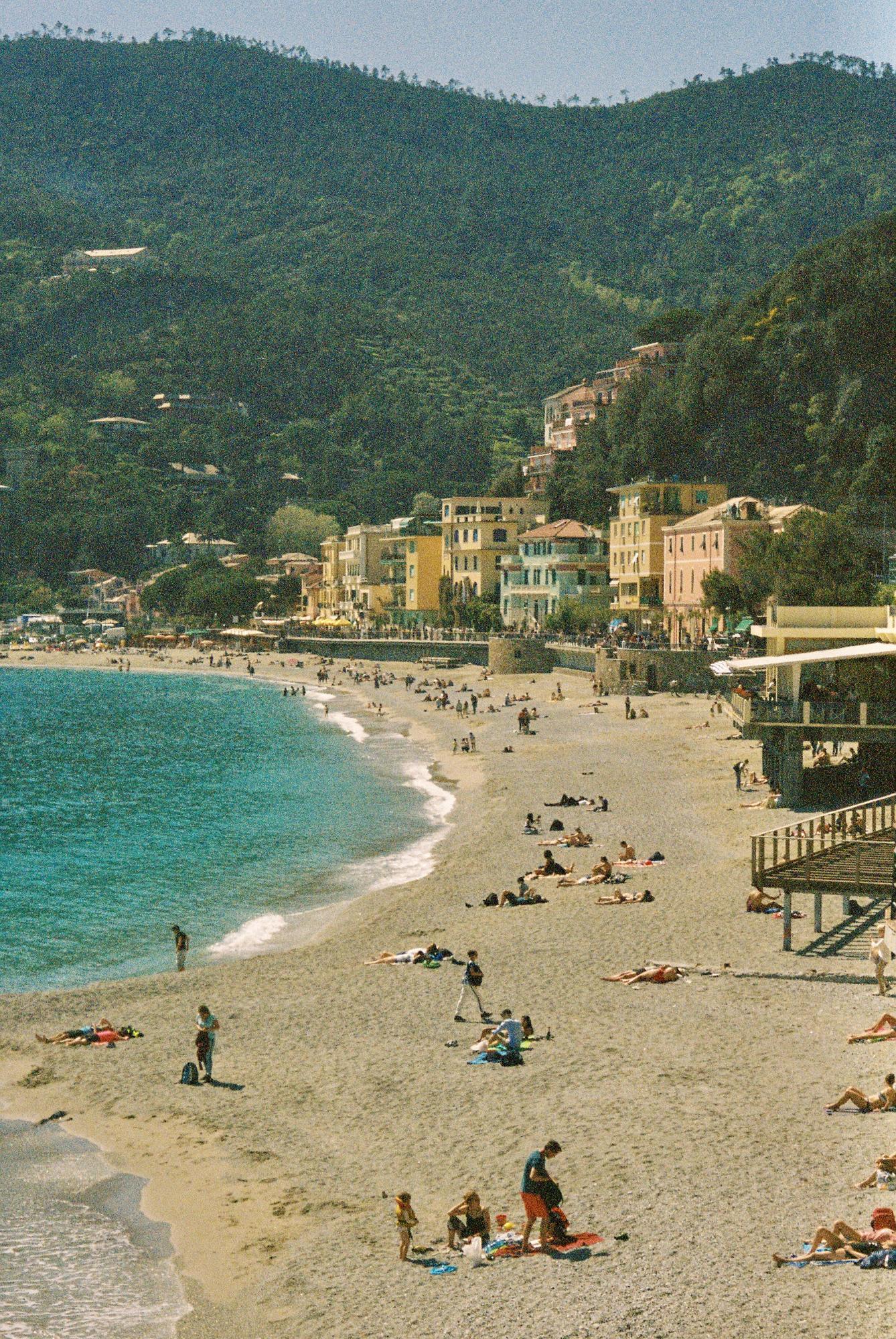 The vibrant Italian coast in the spring filled with people on the beach.