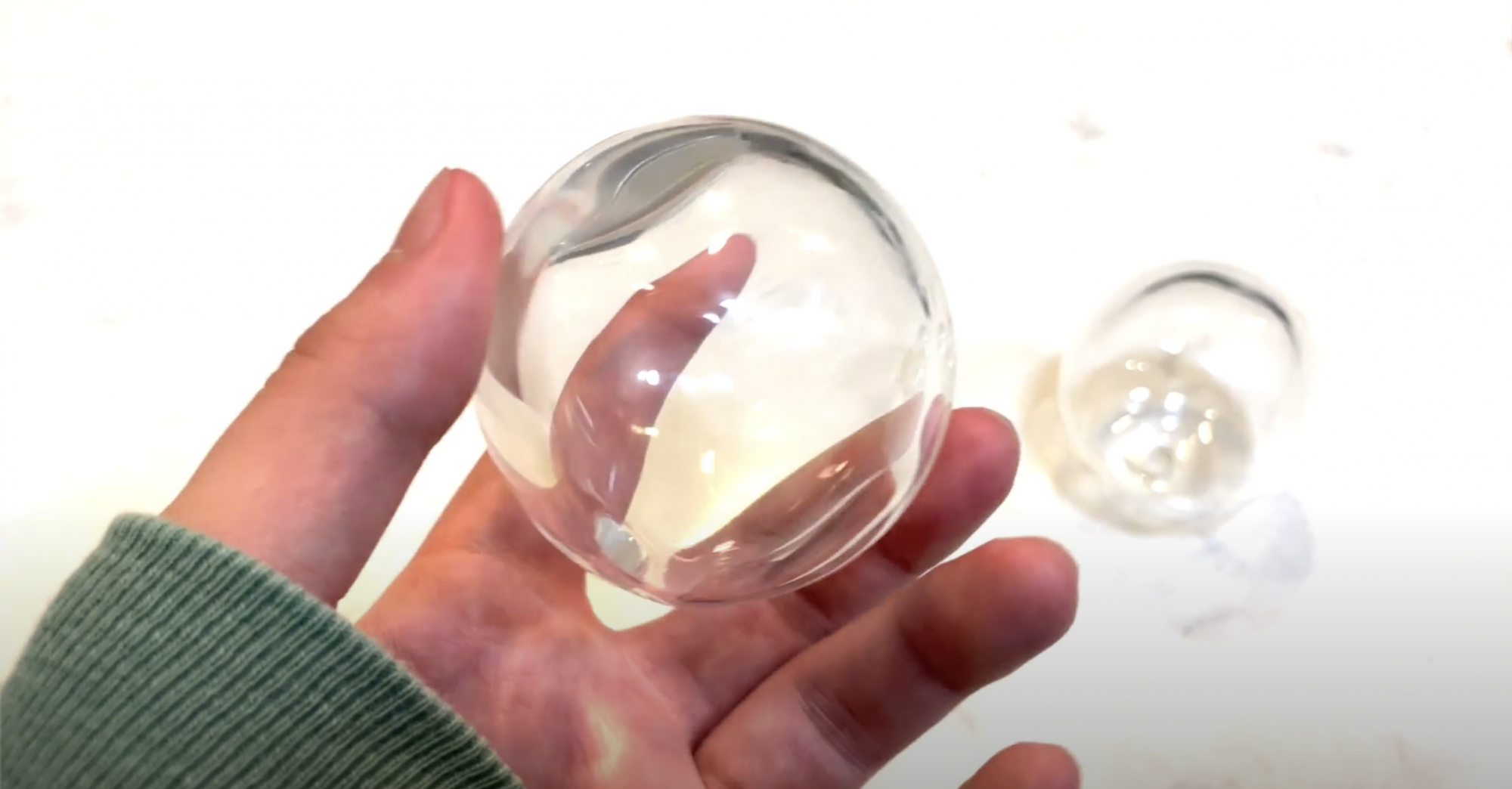 Holding a glass sphere in hand