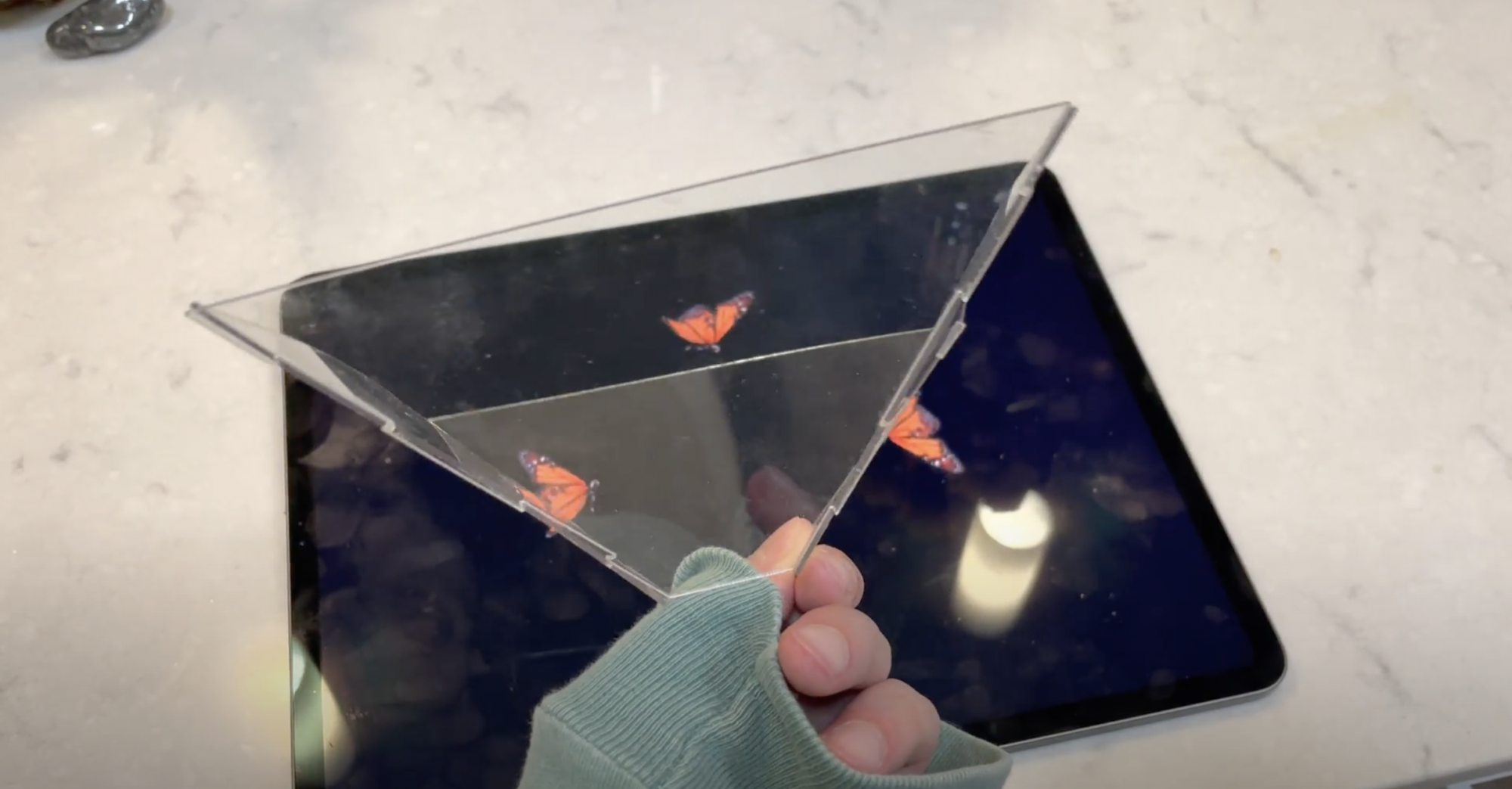 A four-sided pyramid object composed of clear plastic