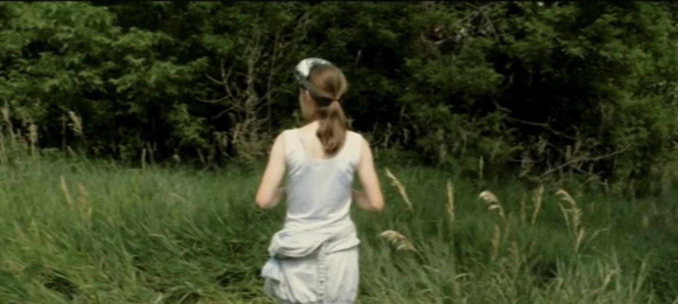 a woman standing in a field