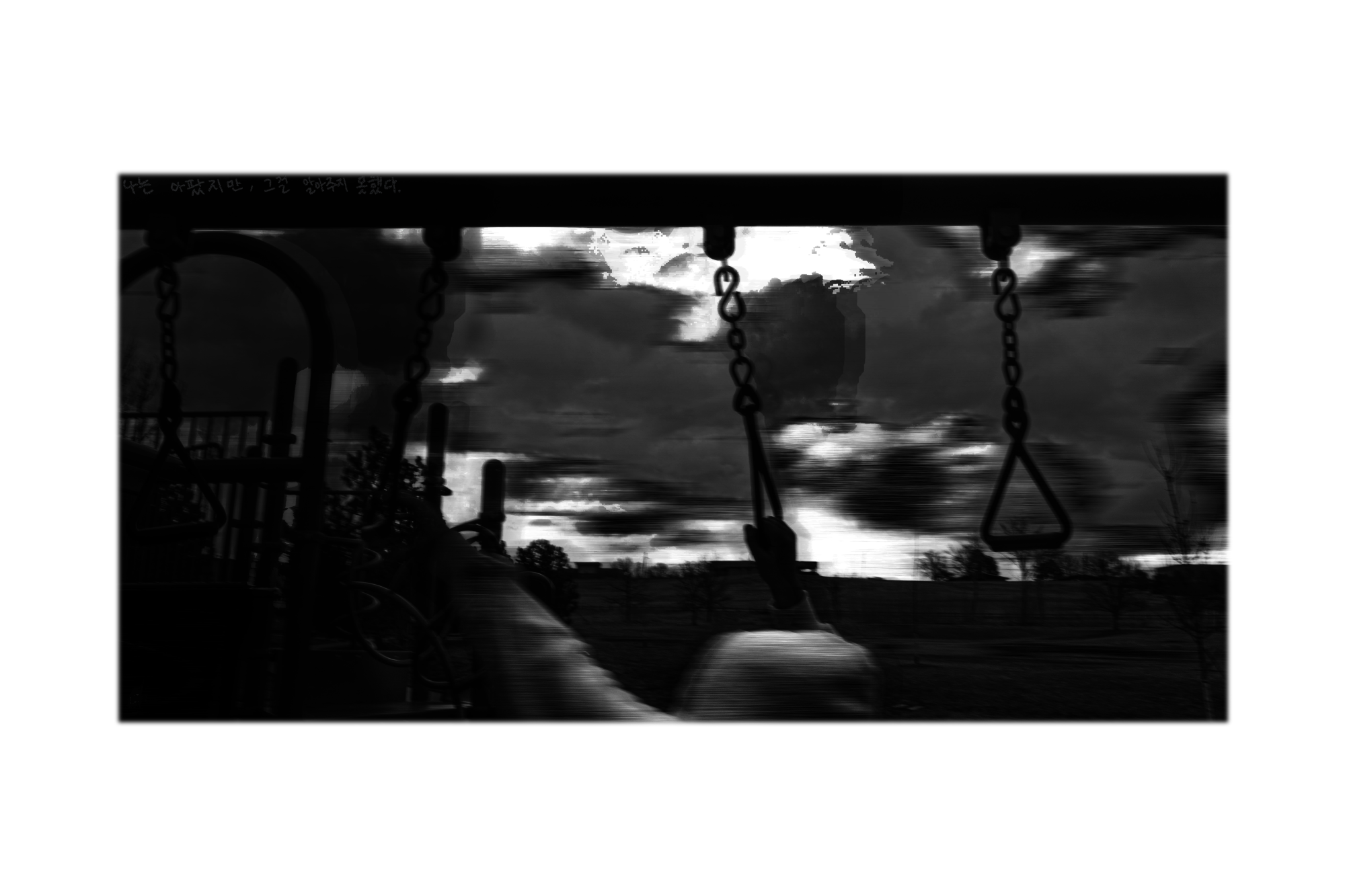 a black and white photo of a blurred figure in a cloudy background holding onto swinging chains
