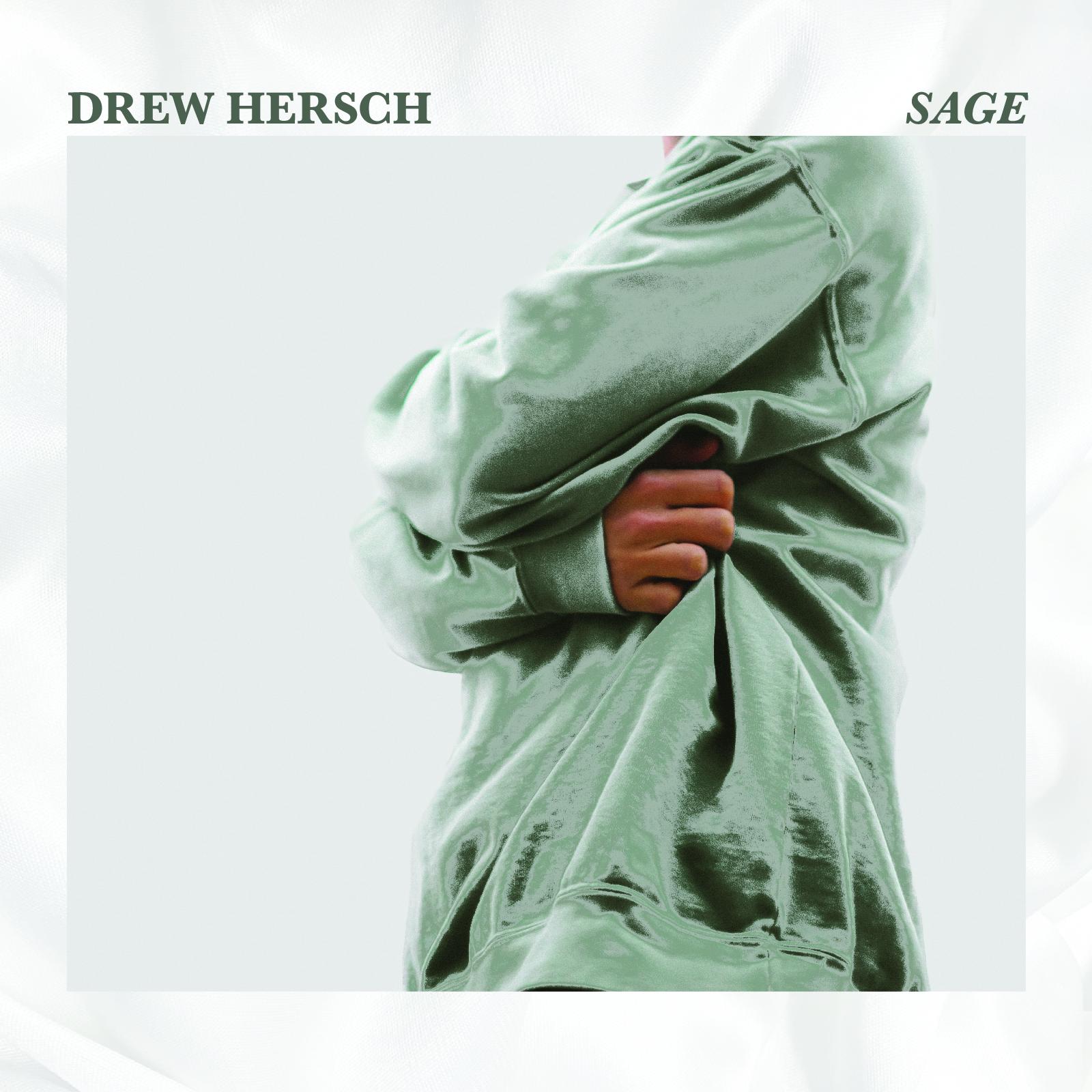 'sage' EP cover. Here, I am hugging myself in a shiny, satin sage green sweatshirt. The image has a textured frame of a white bed comforter.