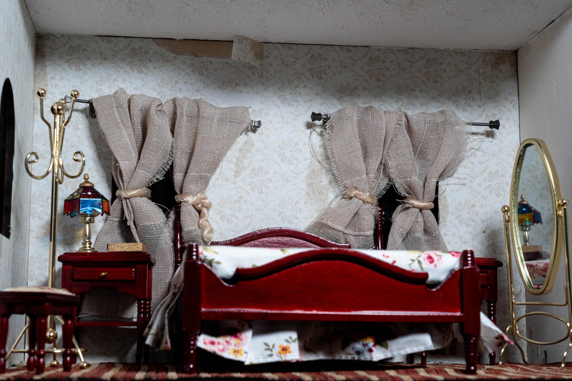 Another full shot of motel room focusing on the popcorn ceiling and the peeling wallpaper revealing stained walls