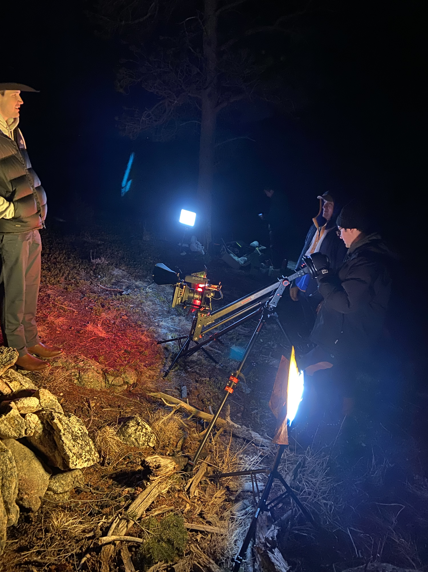 A film crew is shooting at night outdoors