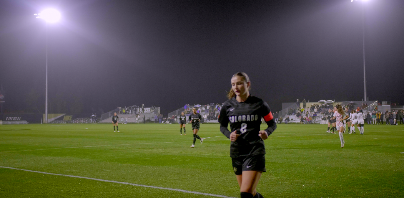 female soccer player running to the sidelines