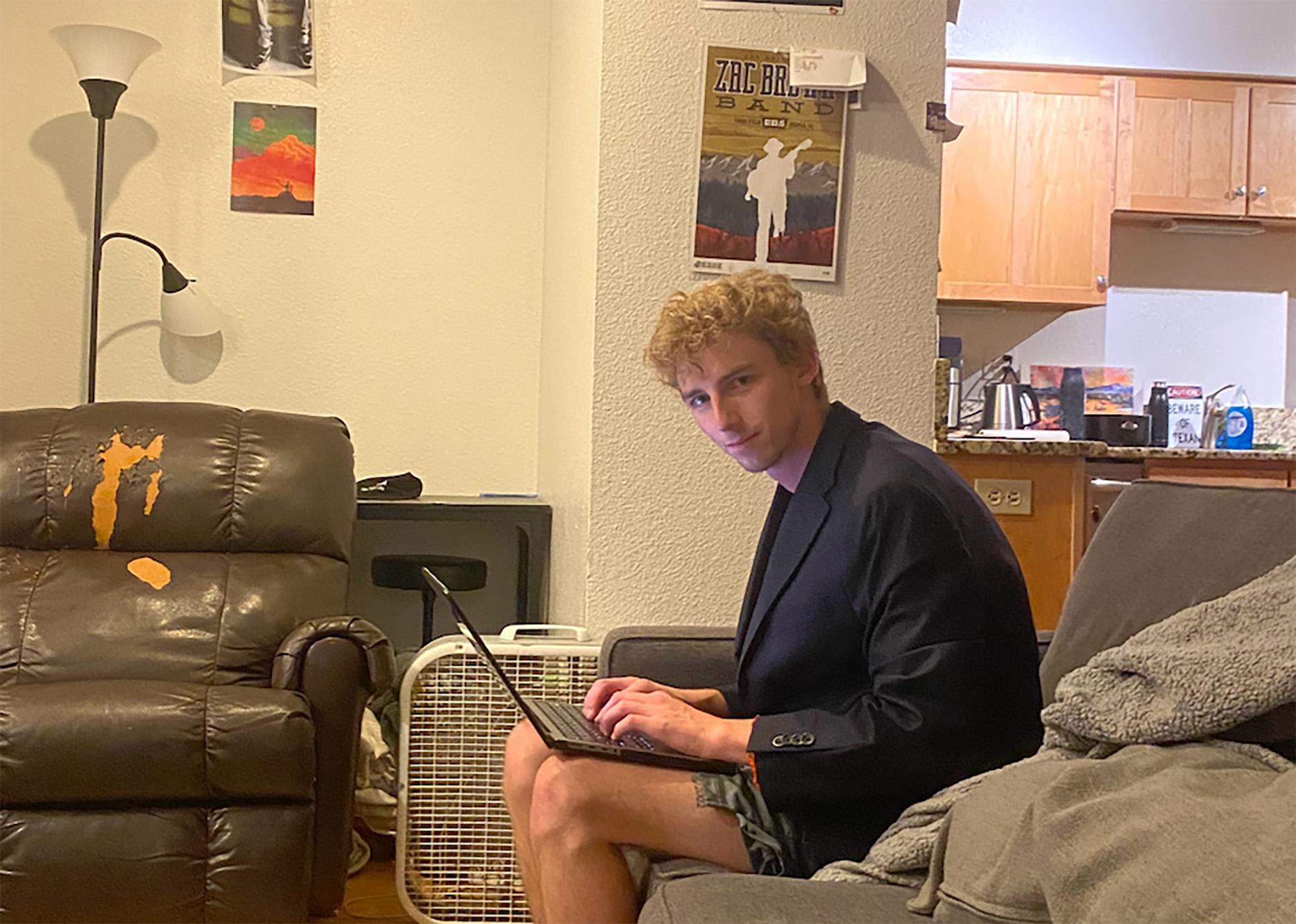 man typing on a laptop