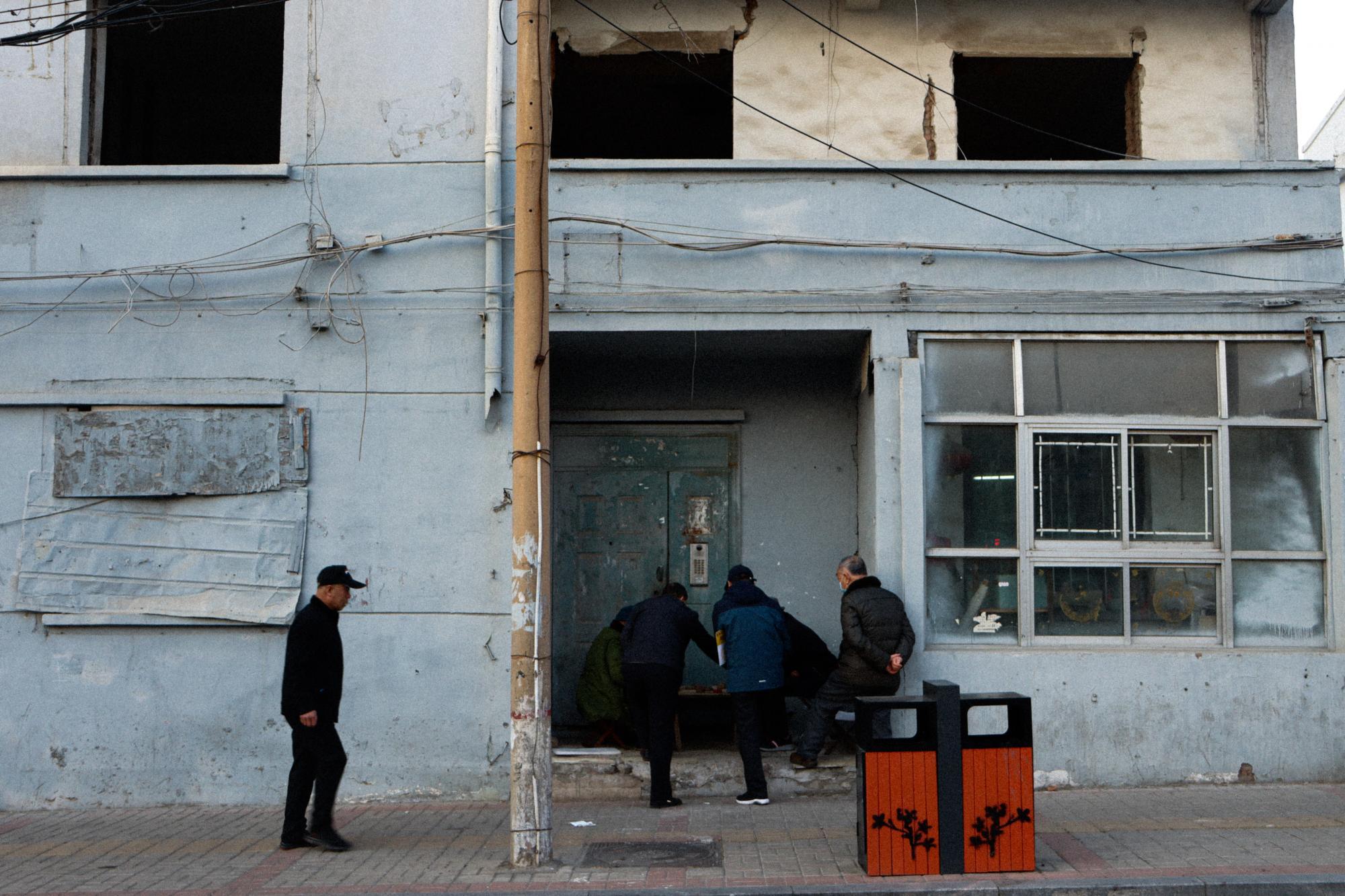 Four people outside a storefront