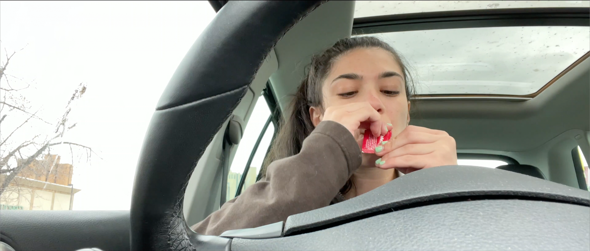 Person in a car behind the steering wheel