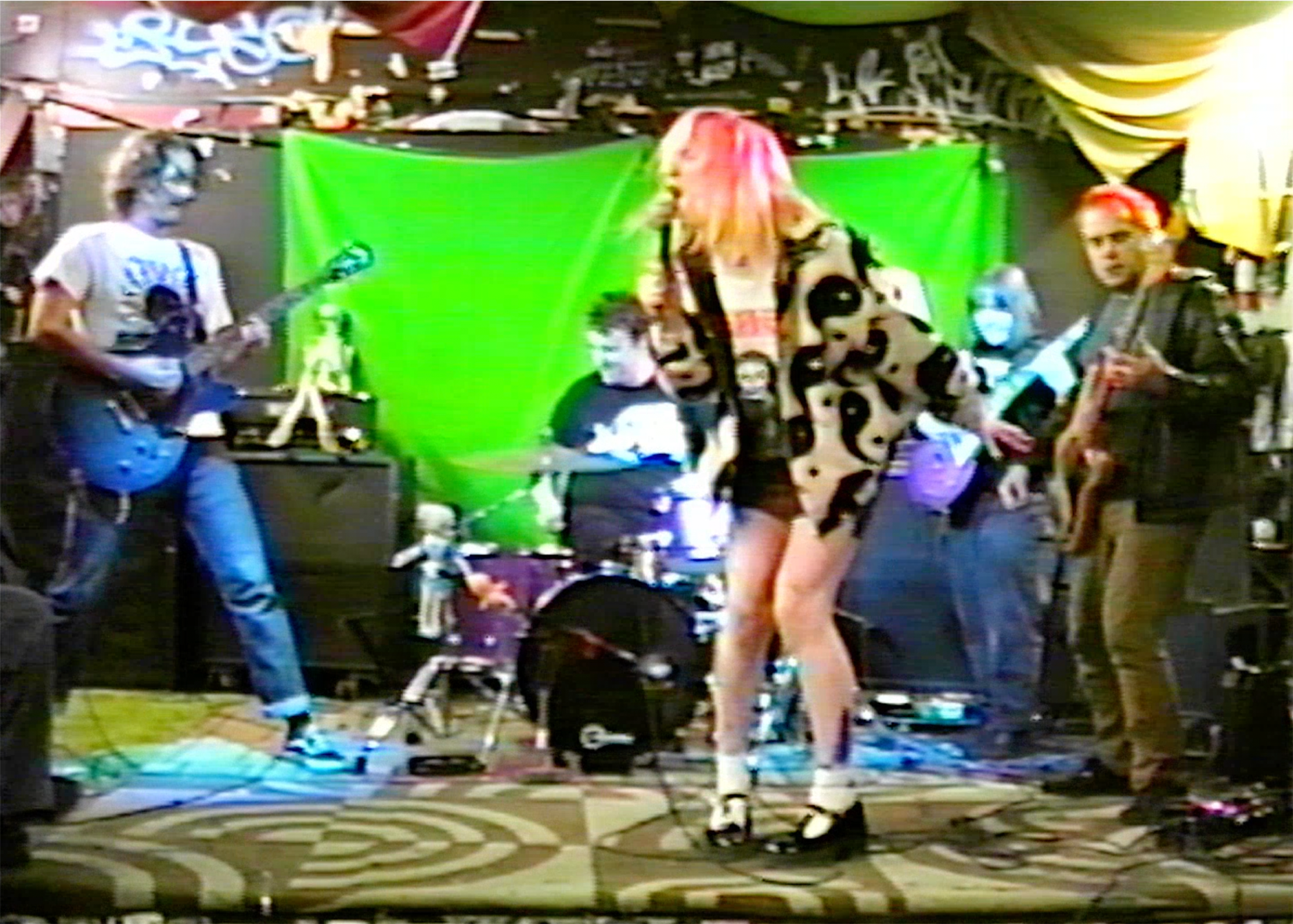 person yelling into a microphone on a live music set